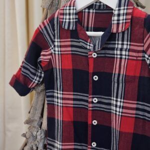 the Larkwood Tartan Romper Pyjamas showing a front view displayed hanging from an ornamental twig tree