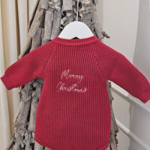 the 'Merry Christmas' Red Romper displayed hanging from a decorative twig tree.