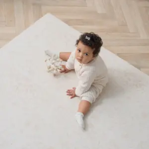 toddler playing on the Tutti Bambini Infinity Baby Playmat in Bedouin Sand