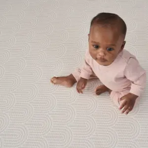 Baby sitting on reverse side of Tutti Bambini XL Reversible Playmat in Cathedral & Dash