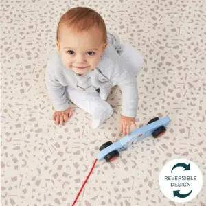 Baby playing on Tutti Bambini Luxury Padded XL Reversible Play Mat with toy