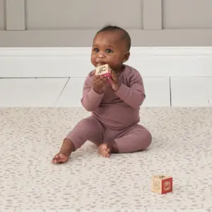 baby playing with blocks on the Tutti Bambini Luxury Padded XL Reversible Play Mat
