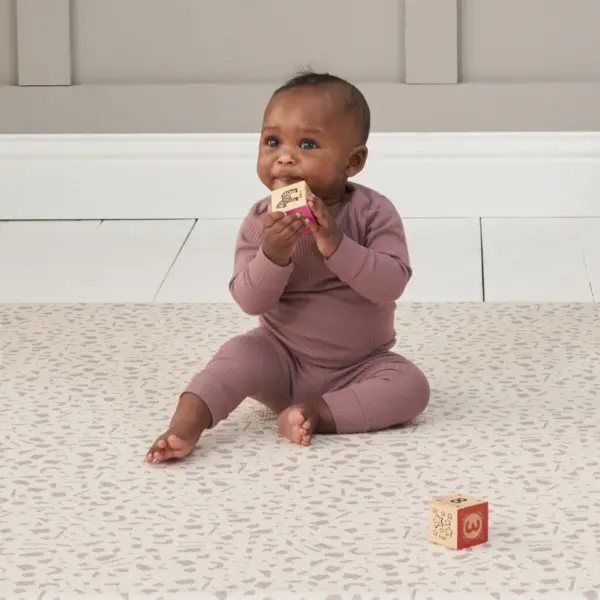 baby playing with blocks on the Tutti Bambini Luxury Padded XL Reversible Play Mat