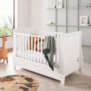 nursery room setting with the Babymore Stella Sleigh Cot Bed in white