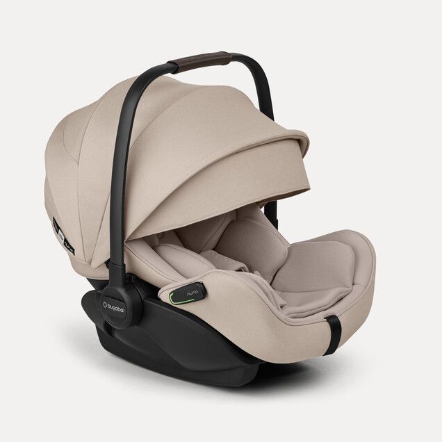 the Otter by Nuna car seat shown in desert taupe melange with sun canopy extended