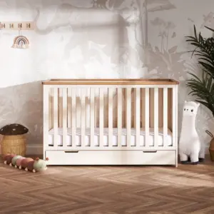 the Obaby Evie Mini Under Drawer in Cashmere shown with the Evie Mini cot in a nursery room setting