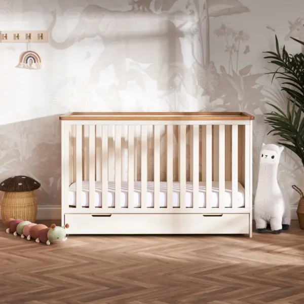 the Obaby Evie Mini Under Drawer in Cashmere shown with the Evie Mini cot in a nursery room setting