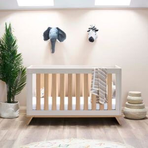 the Obaby Thea Cot Bed in Lattein a nursery room setting with decorative wall hangings