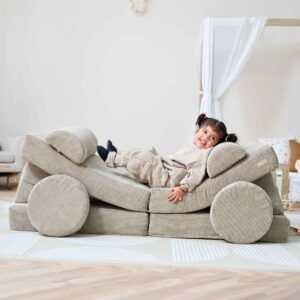 young child playing on the Tutti Bambini Playrama Montessori Kids Play Sofa in Mushroom