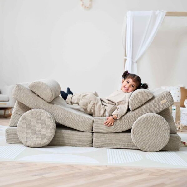 young child playing on the Tutti Bambini Playrama Montessori Kids Play Sofa in Mushroom
