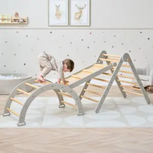 young child playing on the Tutti Bambini Scala Montessori 3 in 1 Pikler Climbing Frame with Climbing Wall in mushroom