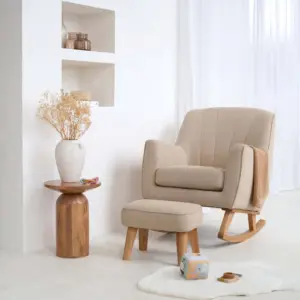 the Clair de Lune Bouclé Rocking Chair & Footstool displayed in a room with rug and ornaments