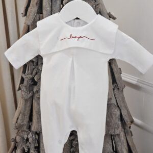 The Baby Store Red 'Love You' Square Collar Babygrow shown hanging on a decorative stick tree